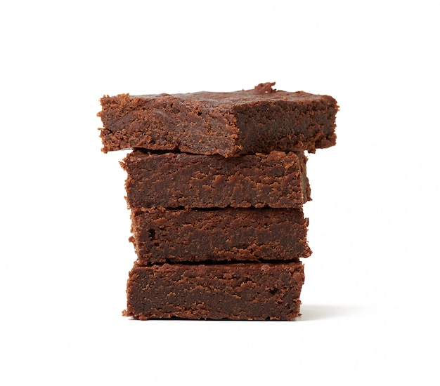 Stack of square baked pieces of brownie chocolate cake isolated on a white