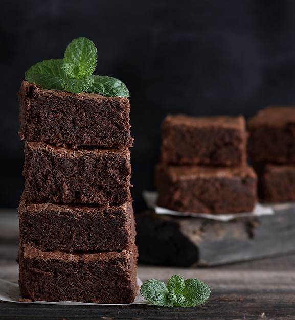 Stack of square pieces of baked brown brownie pie