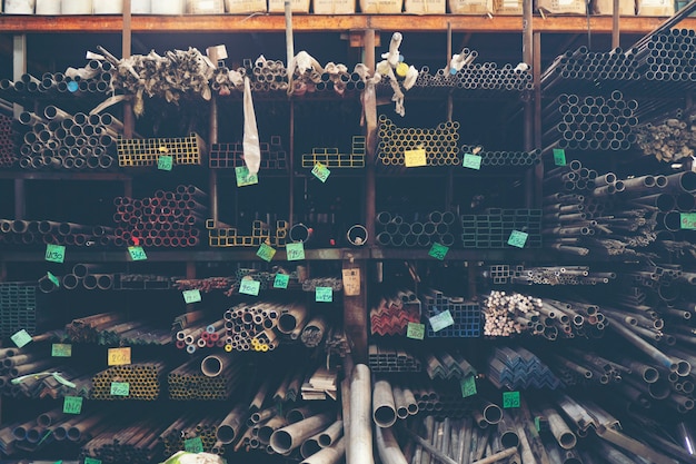 Photo stack of steel pipes in metal factory shop