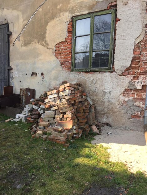 Stack of stone wall by building