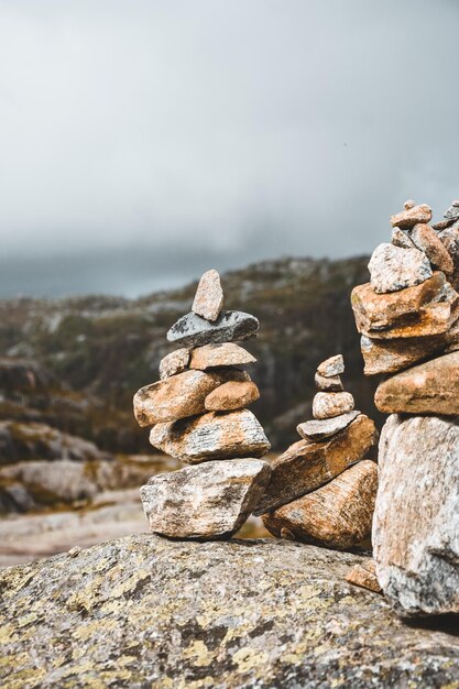 Stack of stones on beach against sky