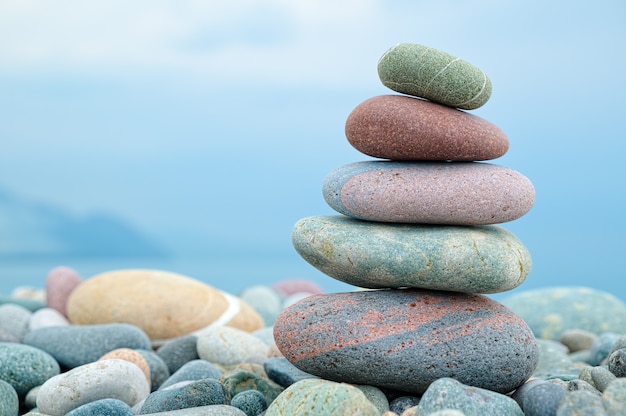 Stack of stones on the beach and sea background