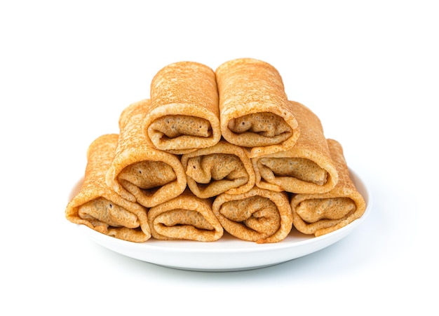A stack of stuffed pancakes in a plate isolated on a white background. Pancake day. Traditional Russian pancakes.