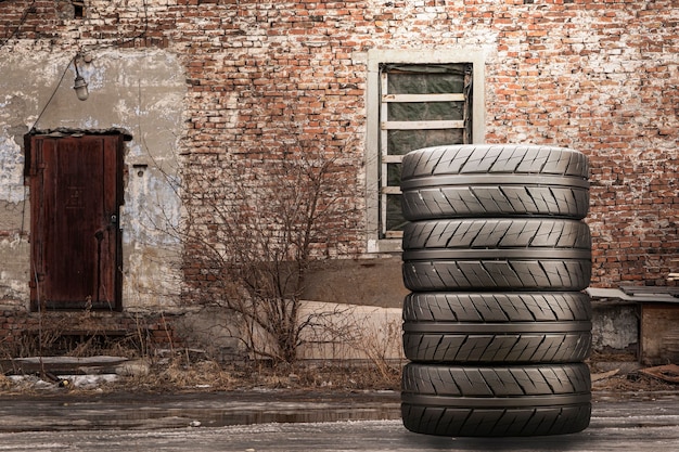 Photo stack of summer tires against a brick wall