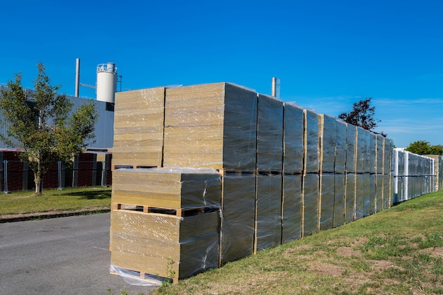 Stack of thermal insulation mineral boards or glass wool boards warehousing on pallets