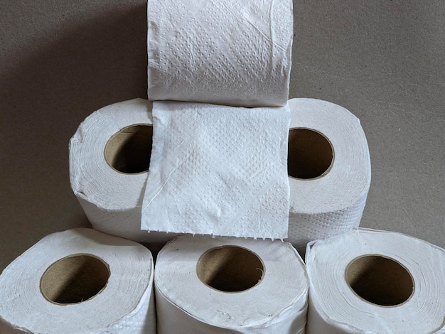 A stack of toilet paper is stacked up in a pyramid