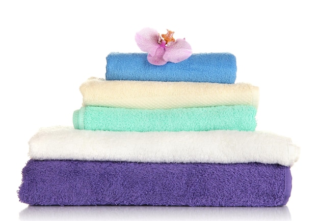 Stack of towels with fragrant flower isolated on white