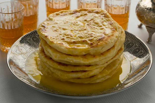 Stack of traditional Moroccan meloui pancakes topped with butter