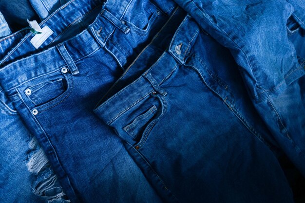 Stack of various shades blue jeans Pile Blue denim jeans texture banner Canvas denim fashion texture