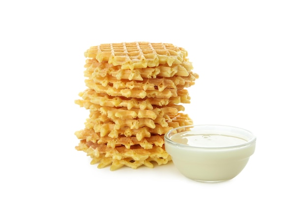 Stack of wafer and condensed milk isolated on white background