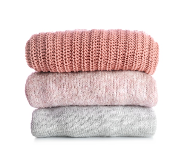 Stack of warm clothes on white wall