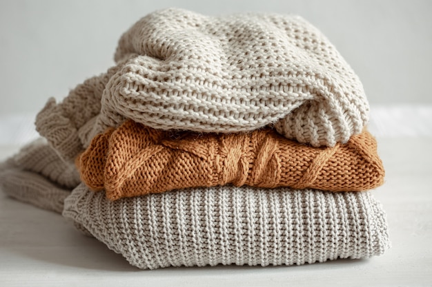 A stack of warm knitted sweaters.