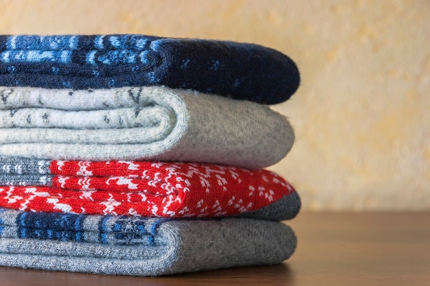 A stack of warm wool socks with colorful patterns