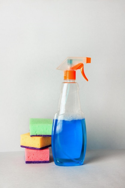 A stack of washing sponges and a cleaner