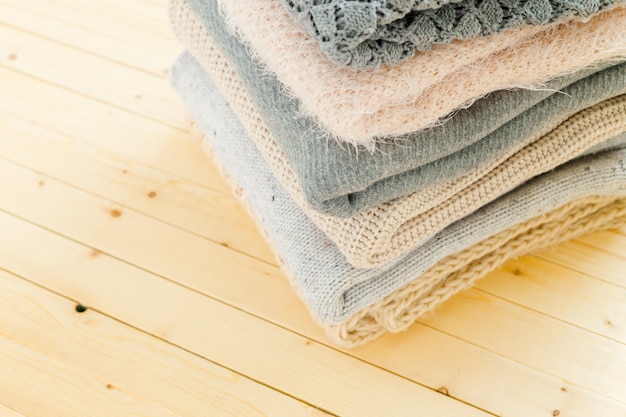 Stack of white cozy knitted sweaters