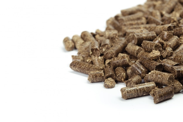 Stack of wooden pellets for bio energy, white background, isolated