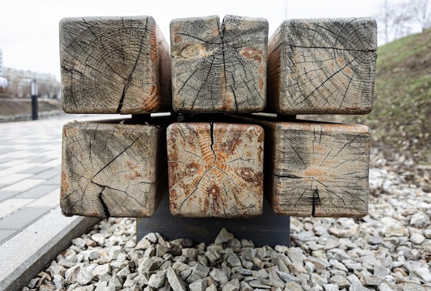 A stack of wooden posts with the word wood on it