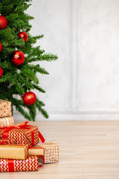 Stack of wrapped presents under Christmas tree