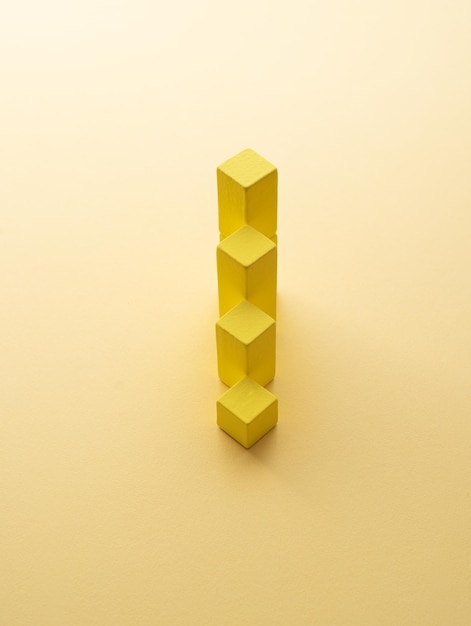 Stack of yellow cubes over yellow background