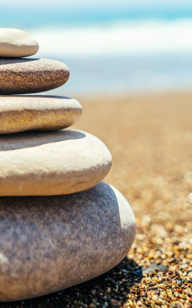 Stack of zen stones on the beach near sea