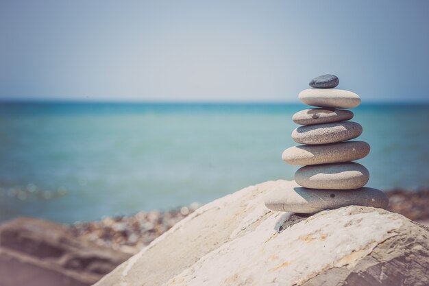 Stack of zen stones near sea. Harmony, balance.