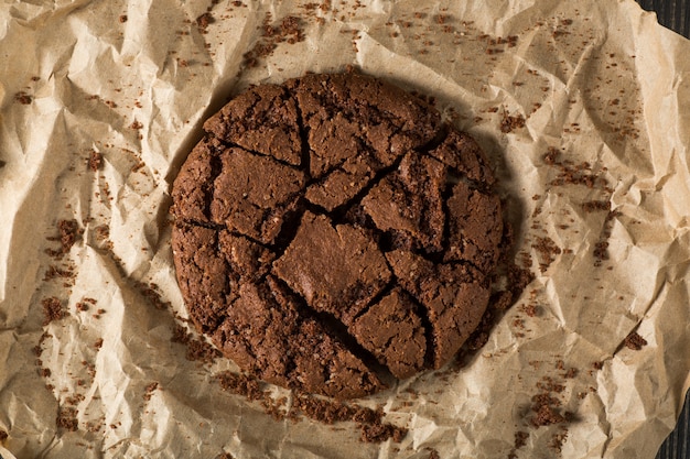 Stacked broken chocolate chip cookies on craft paper