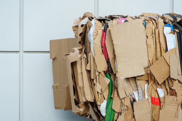 Stacked cardboard and paper products for further processing A waste paper recycling company Paper garbage at the recycling plant Separate garbage collection