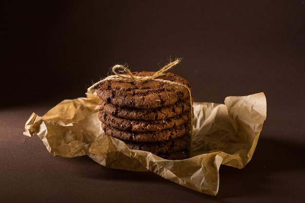 Stacked chocolate chip cookies on craft paper