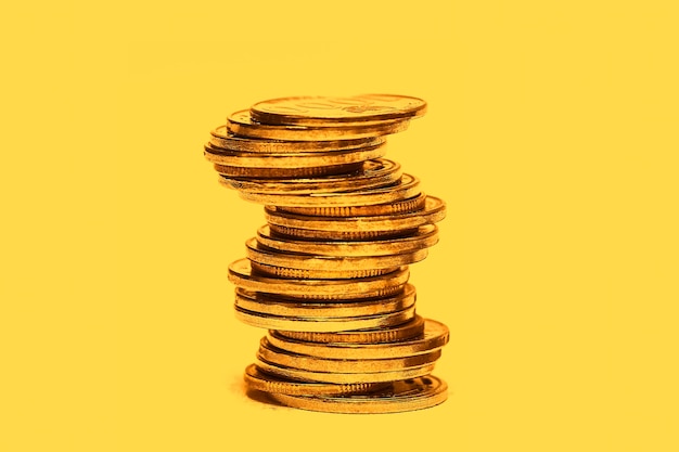 Stacked coins are placed on a gold background