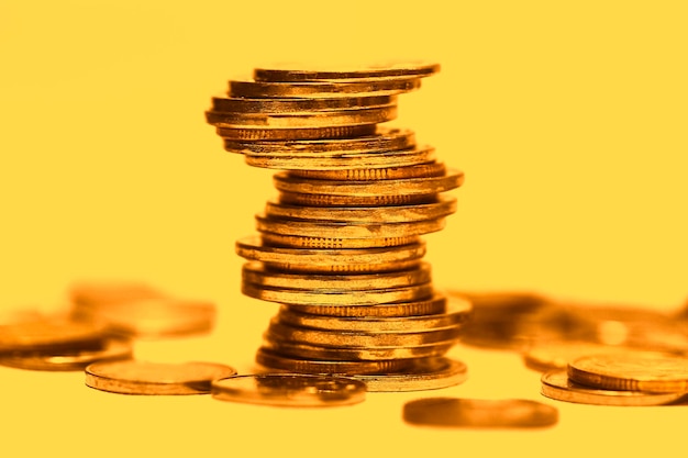 Stacked coins are placed on a gold background