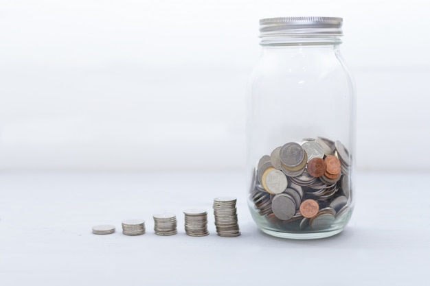 stacked coins and inside glass jar