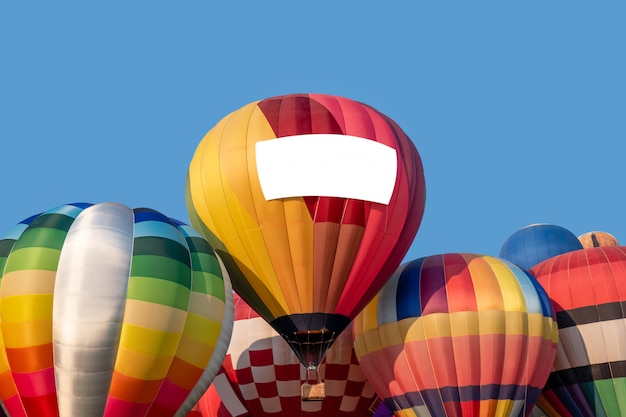 Stacked colorful hot air balloons with blue sky