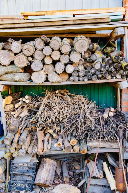 Stacked firewood and dry branches firewood for kindling stoves barbecue