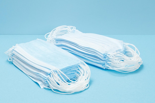 stacked medical masks on a blue background