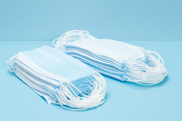 Stacked medical masks on a blue background