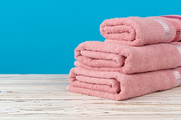 Stacked new towels on a wooden table