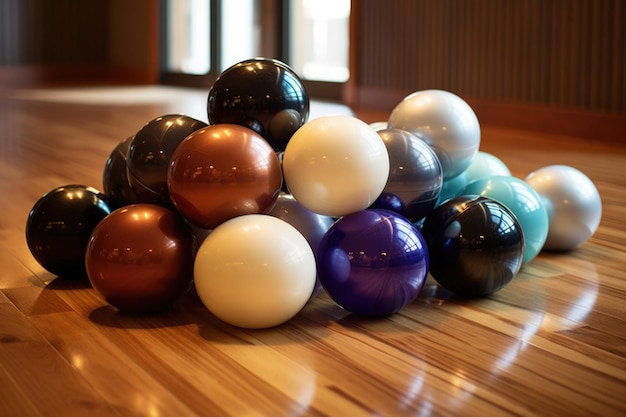 Stacked pilates balls on a wooden floor