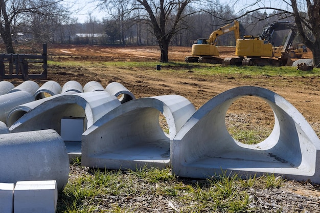 Photo stacked pipe at concrete drainage pipes for building on a construction site