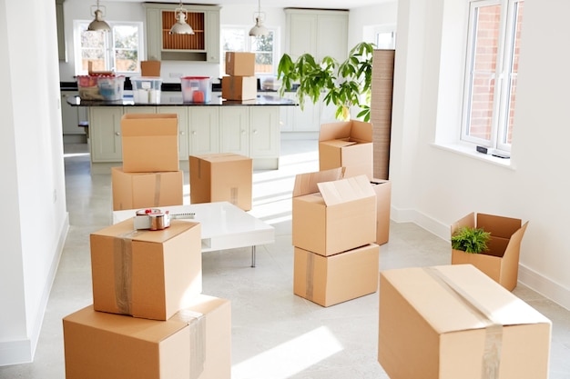 stacked removal boxes in empty room on moving day