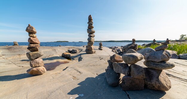 Stacked Rocks balancing, stacking with precision. Stone tower on the shore. Copy space.