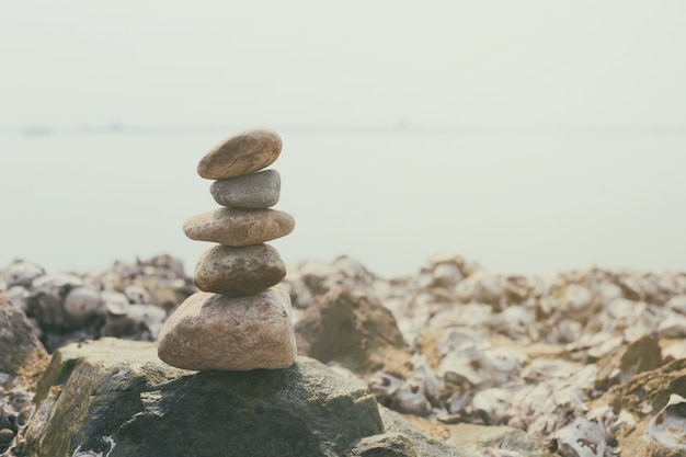 Photo stacked of stones on the summer coast in calmness.