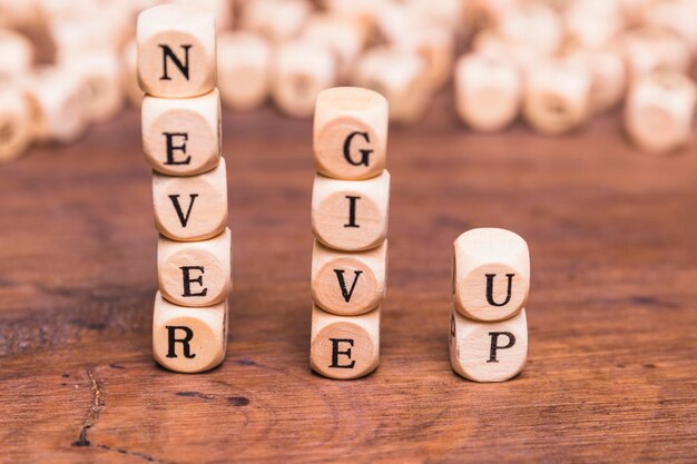 stacked wooden blocks with word never give up wooden desk