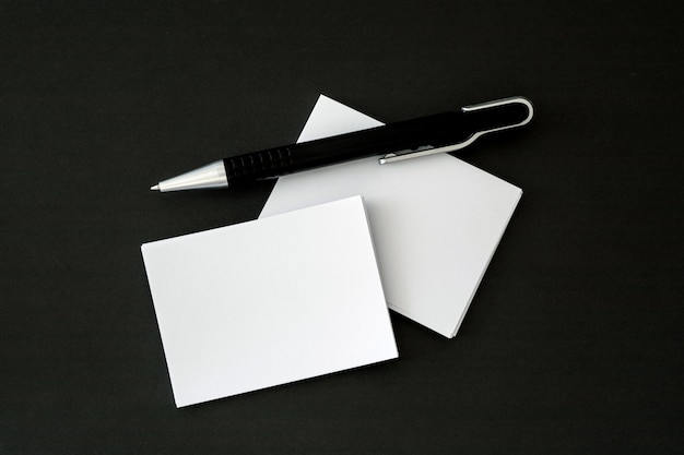 stacking of a mockup empty white business card with elegance pen  on shiny luxury backgrou