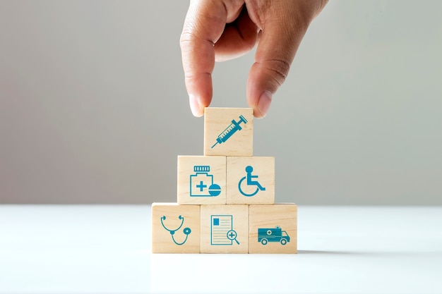 Stacking wooden blocks human hand health care icons and medical icons