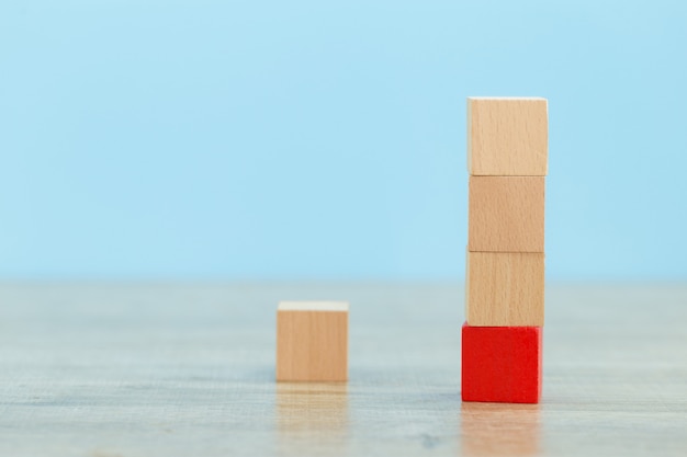 stacking wooden blocks into steps,concept of business growth success