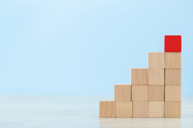 Stacking wooden blocks into steps,concept of business growth success