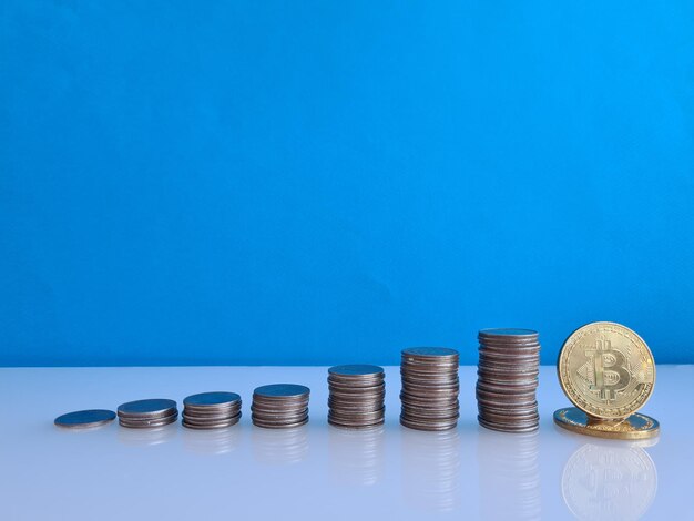 Stacks of coins and golden bitcoin benefit of cryptocurrencies