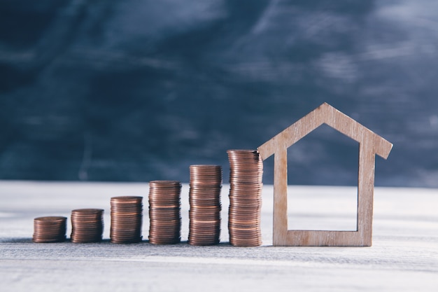 Stacks of coins and old model house