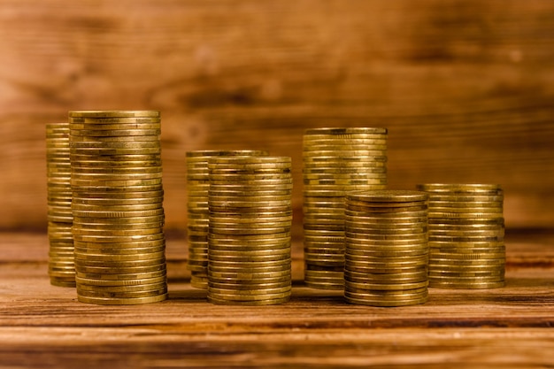 Stacks of the coins on rustic wooden table