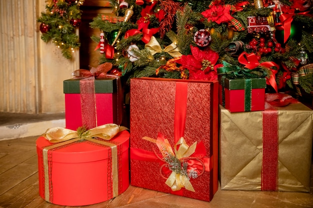 Stacks of colorful presents under a Christmas tree